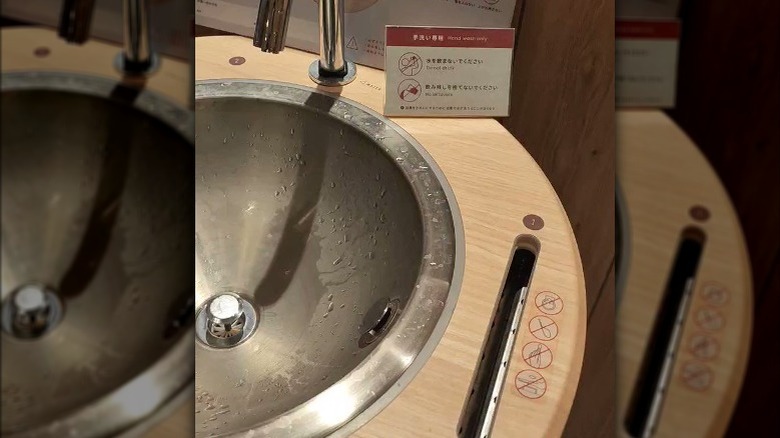 Smartphone cleaner in McDonald's sink