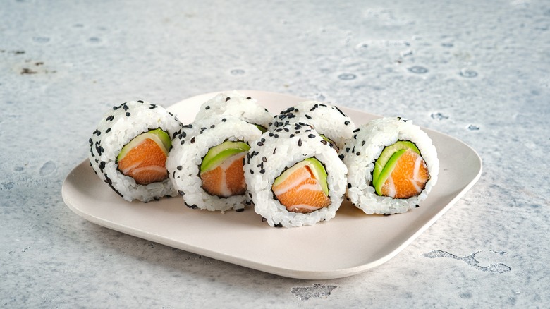 Plate of California rolls with black sesame seeds