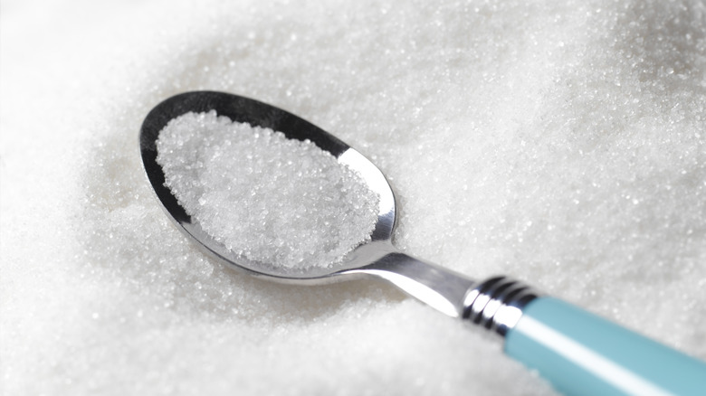 pile of sugar with spoon 