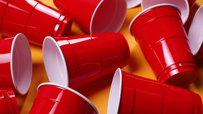 collection of red solo cups on orange background