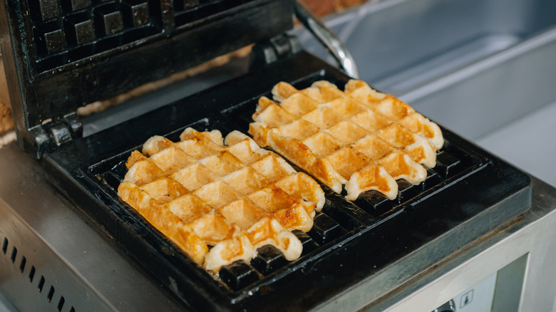 waffles cooking in waffle iron