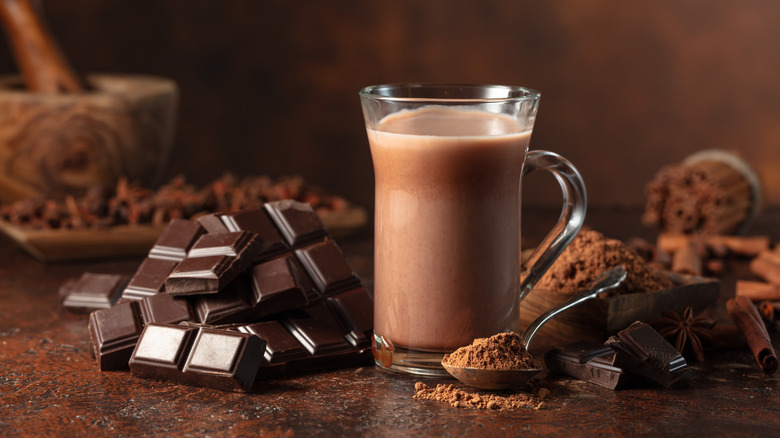 hot chocolate in a glass mug with chocolate pieces