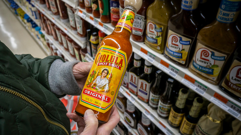 Shopper holds Cholula hot sauce