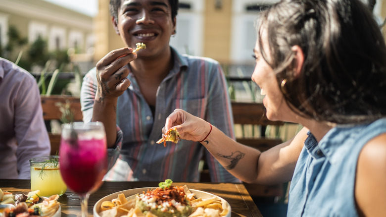 People enjoying snacks and cocktails