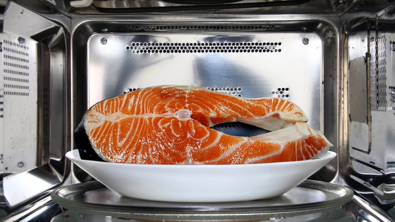 Salmon fillet thawing in the microwave oven