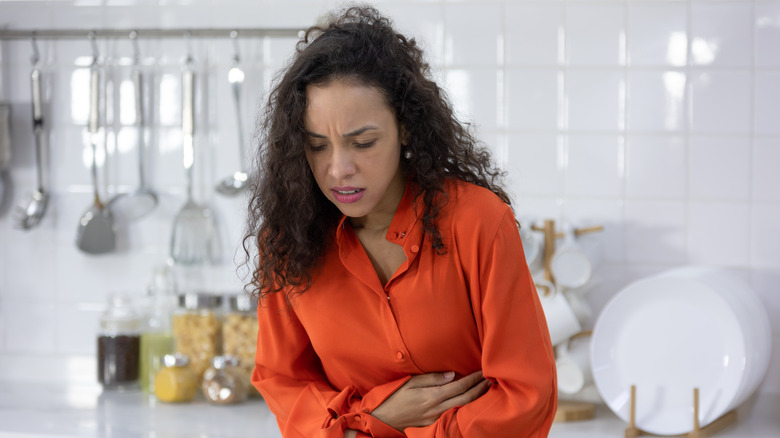 Woman having stomach pain due to food poisoning