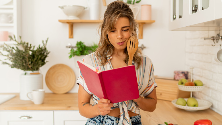 Woman reading recipe in kitchen