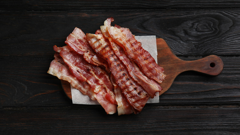 Slices of bacon on cutting board over coffee filter