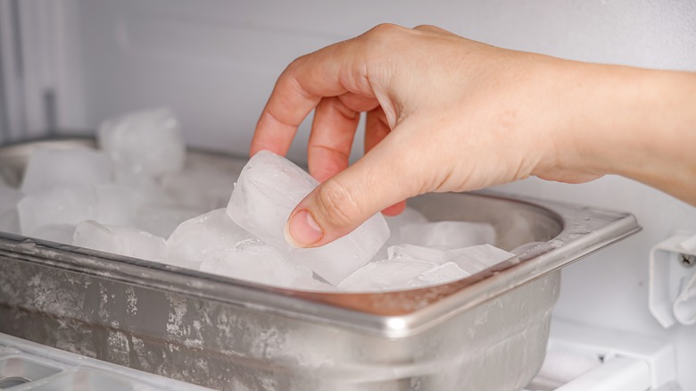 hand grabbing ice cubes