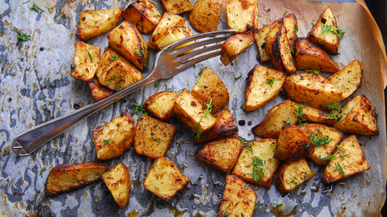 roasted potatoes on a tray with fork