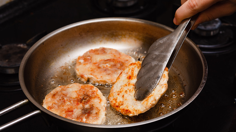 flipping turkey burgers in pan