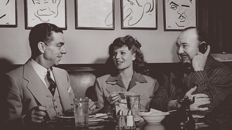 Robert Cobb, Rita Hayworth, and Paul Whitman seated at the Hollywood Brown Derby