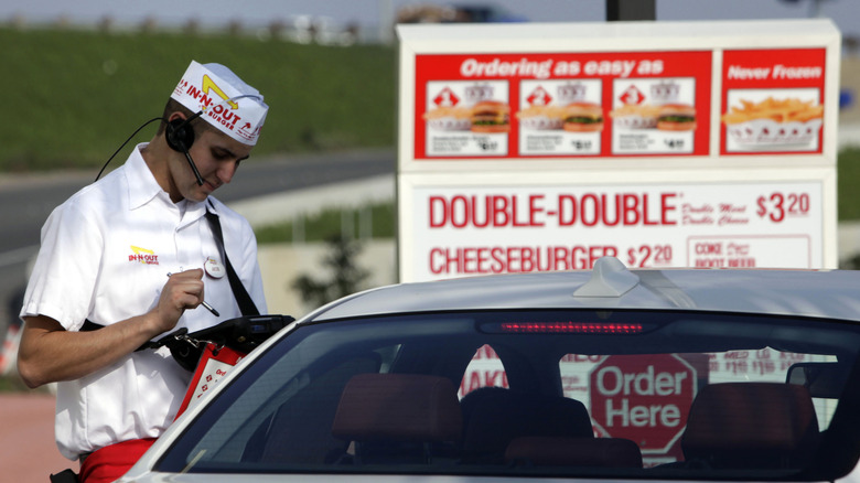 In N Out worker taking order