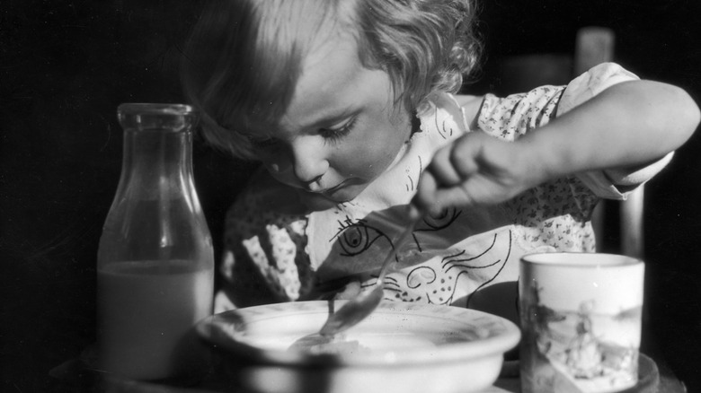 Young girl eating breakfast cereal