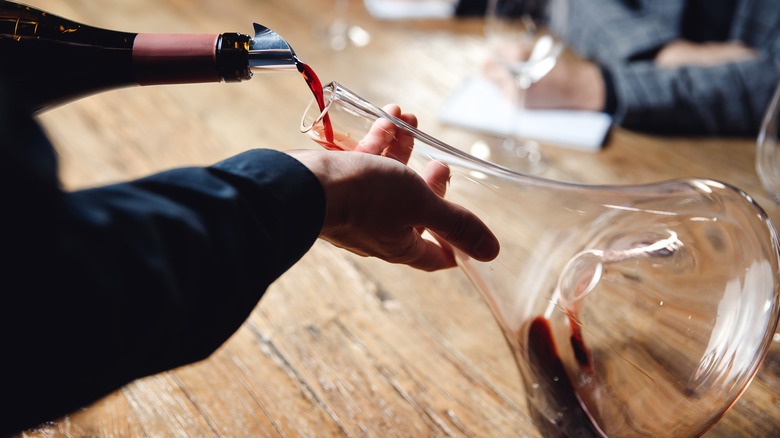 Red wine poured into decanter