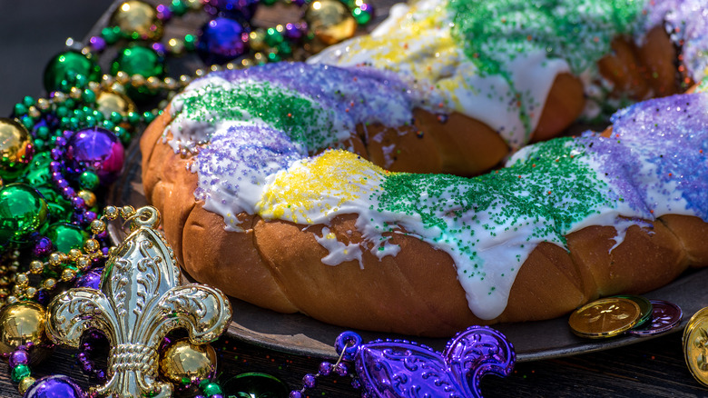 A king cake surrounded by beads