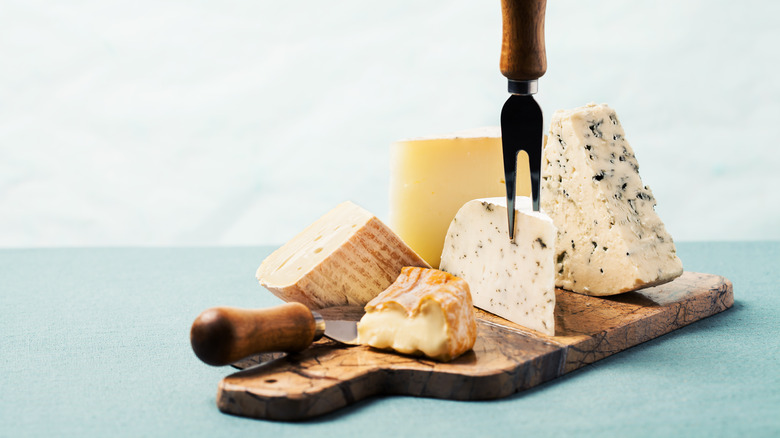 aged cheeses on cutting board