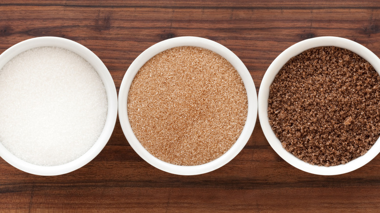 White, turbinado, and brown sugar in bowls