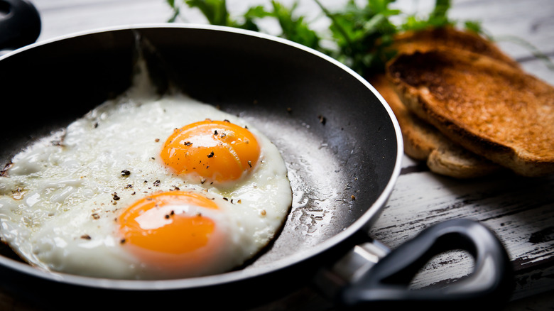 Two fried eggs in pan