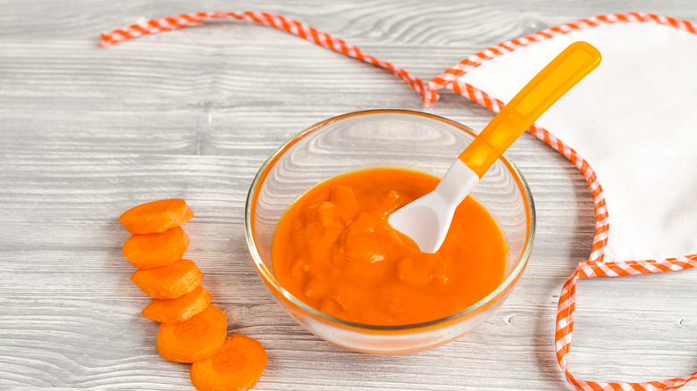 carrot purée with spoon and bib