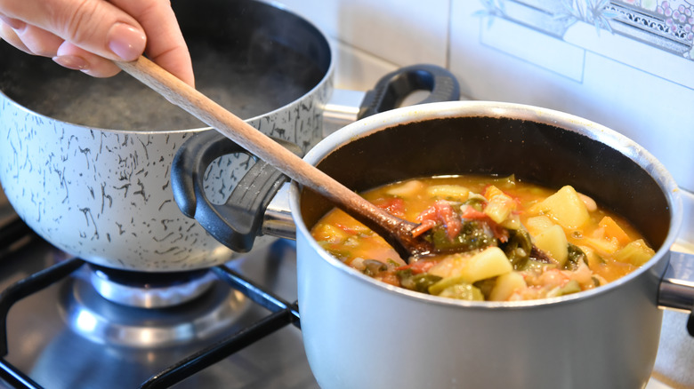 Person cooking minestrone soup