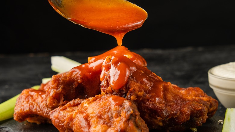 Buffalo sauce pouring on wings