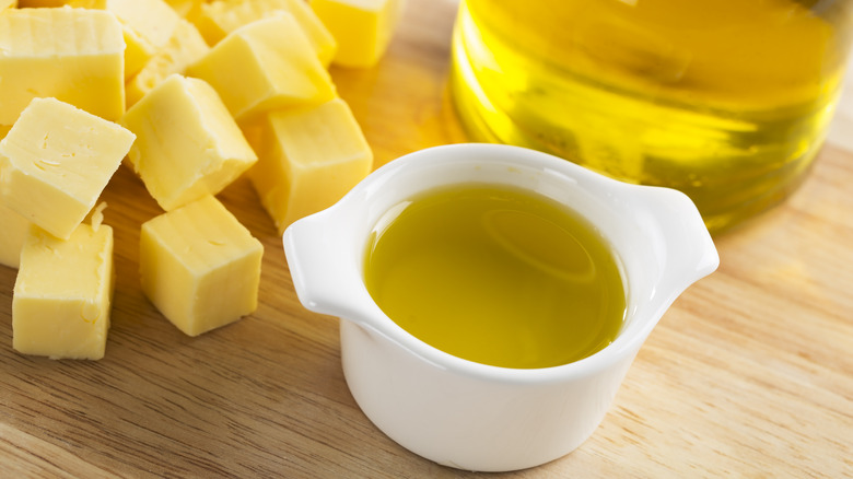 small cubes of butter next to a dish of oil