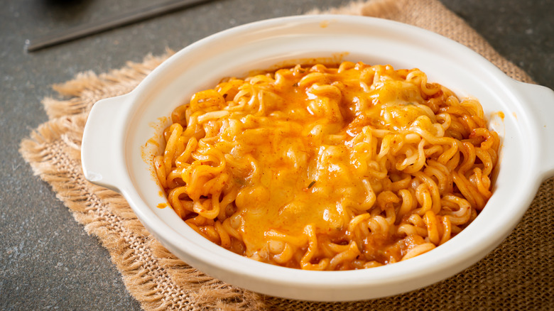 ramen in bowl with melted cheese on top