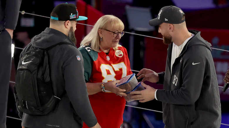 Donna Kelce giving cookies to her sons Jason and Travis