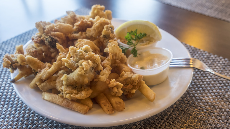 fried clams with fries, sauce, and lemon