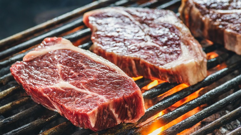 marbled steak cuts on grill