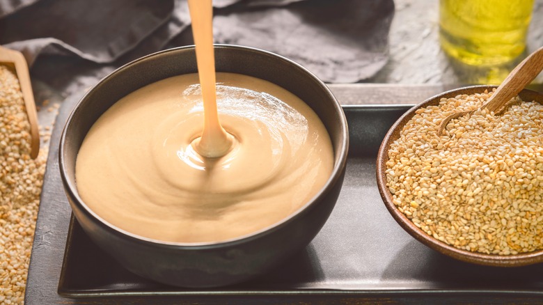 Fresh tahini poured into bowl