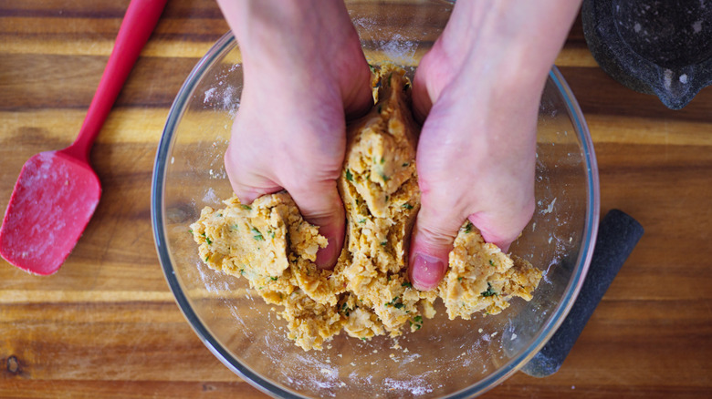 mixing together veggie burger ingredients in bowl