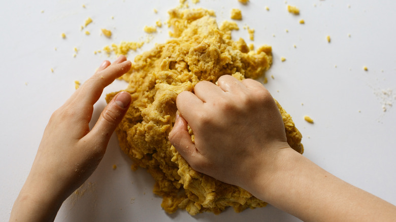 hands kneading masa dough