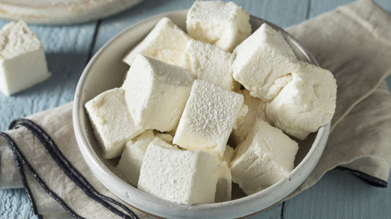 a wood bowl full of homemade vanilla marshmallows