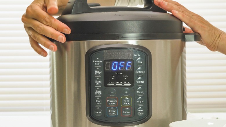 person sealing instant pot