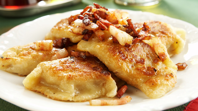 A plate of pierogi with bacon 