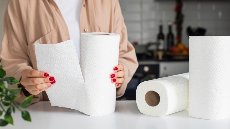 person unrolling paper towels