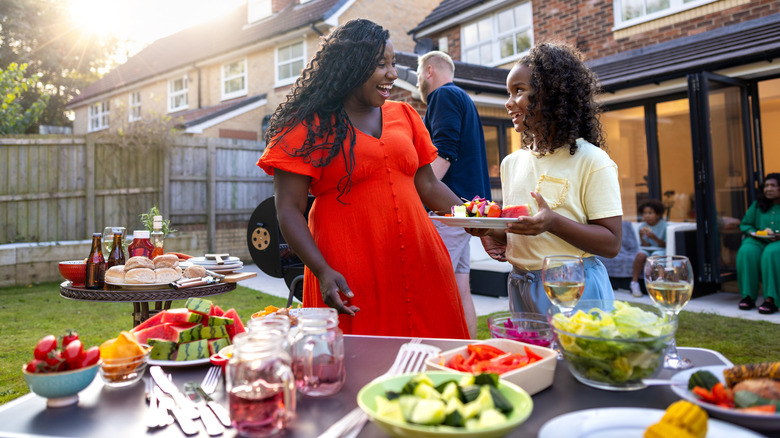 People enjoying backyard cookout