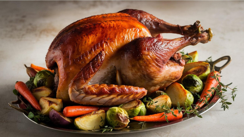 Roasted turkey on platter with various vegetables