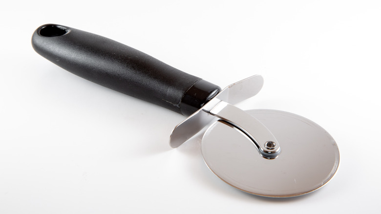 Pizza cutter on white background