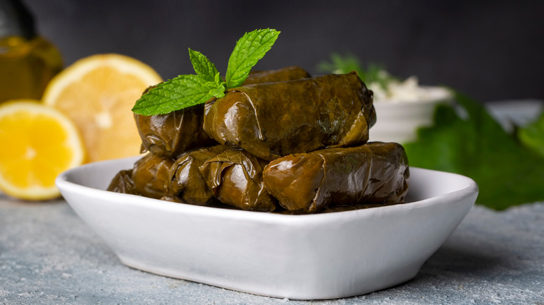 Grape leaf wrapped Greek dish in white bowl