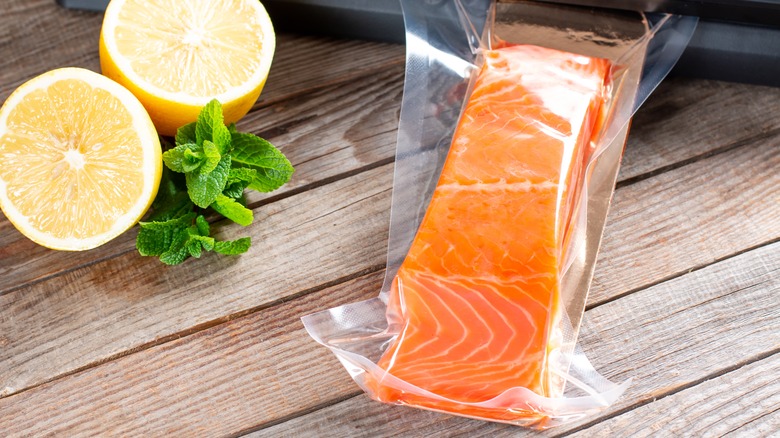 Freeze wrapped salmon fillet with fresh lemons