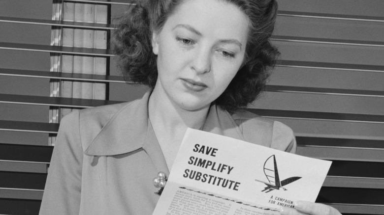 WWII-era woman reading government pamphlet