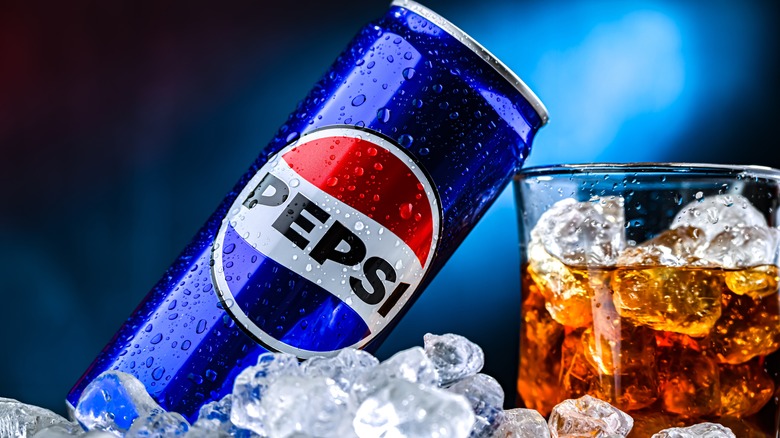 can and glass of Pepsi on ice