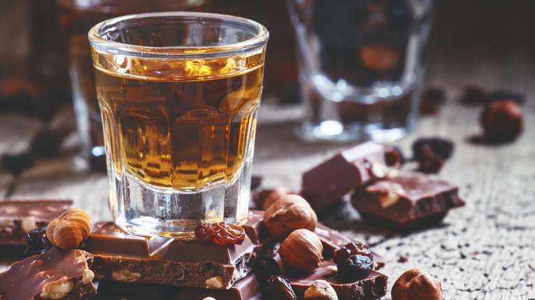 glasses of amaretto surrounded by chocolate and nuts