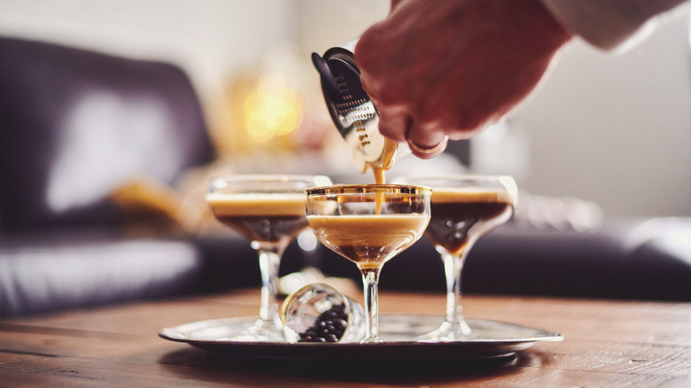 Person pouring espresso martinis