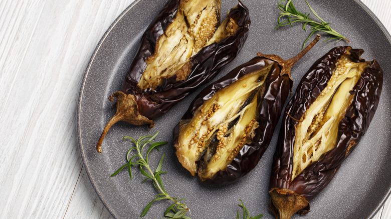 three roasted eggplants