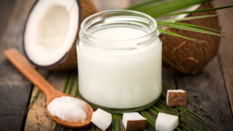 jar of coconut oil with wooden spoon