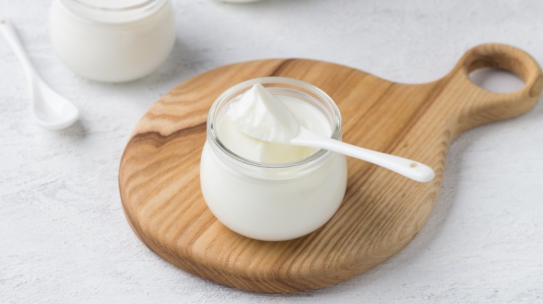 yogurt in glass jar on board